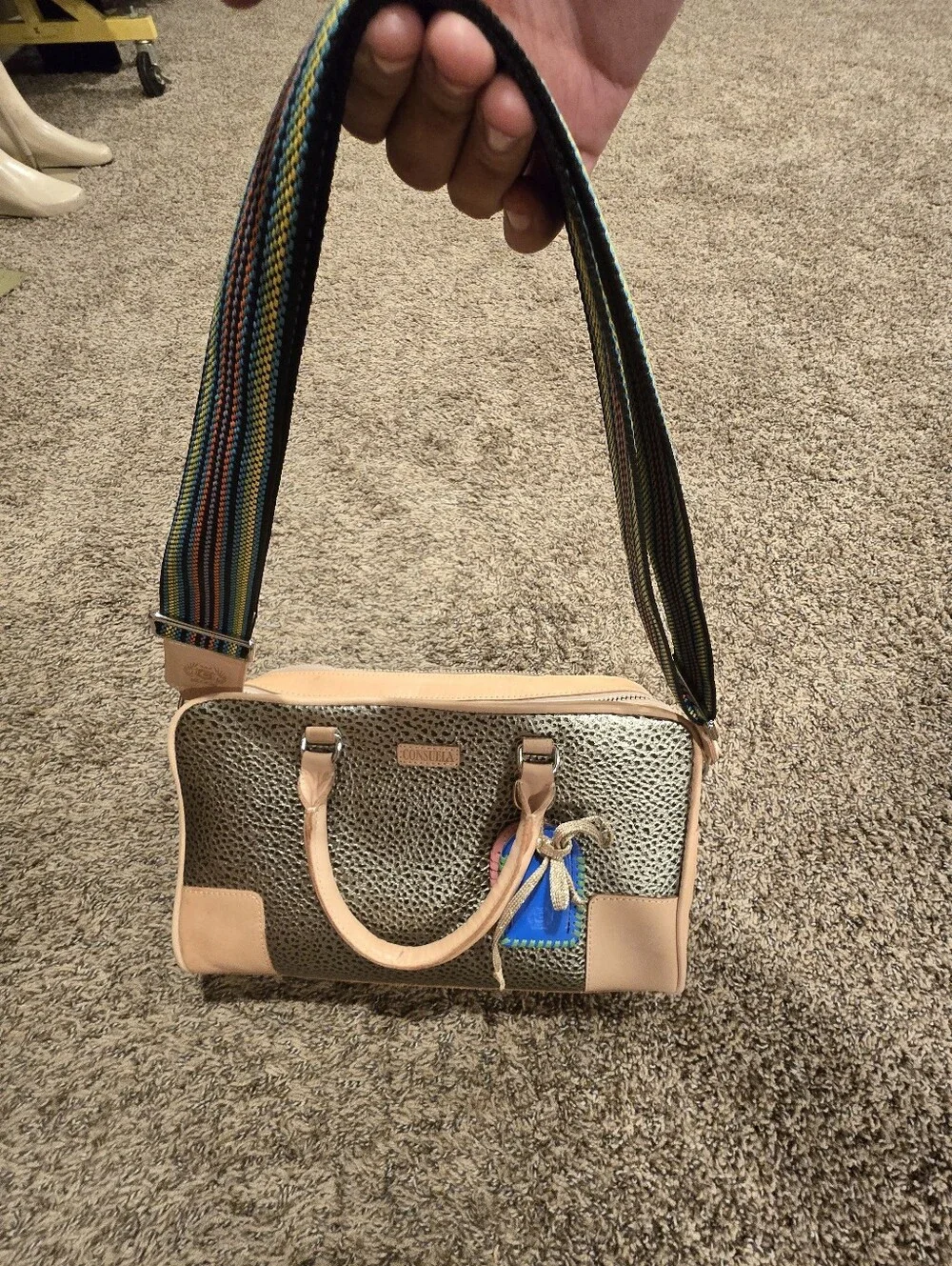 Consuela Tommy Satchel With a textured gold exterior & natural leather handles